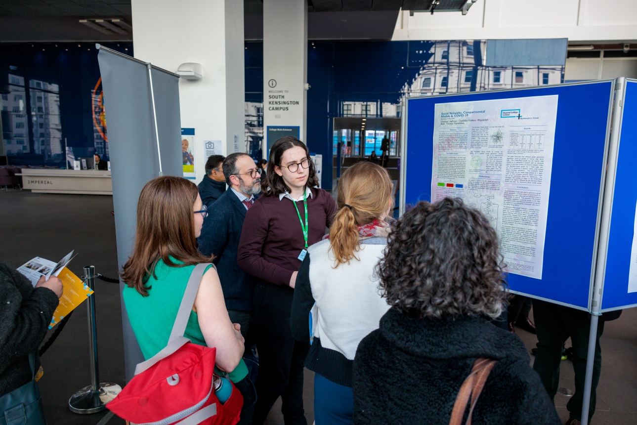 Guests and students taking a look at one of the research project posters